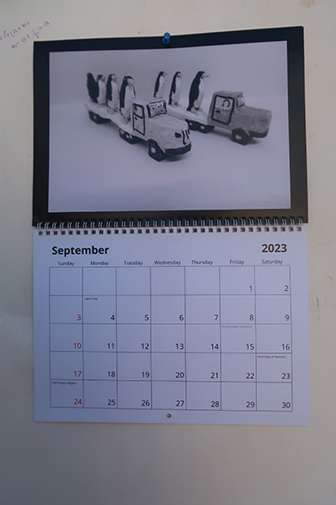 September 2023 calendar-pengin-truck-woodcarving
